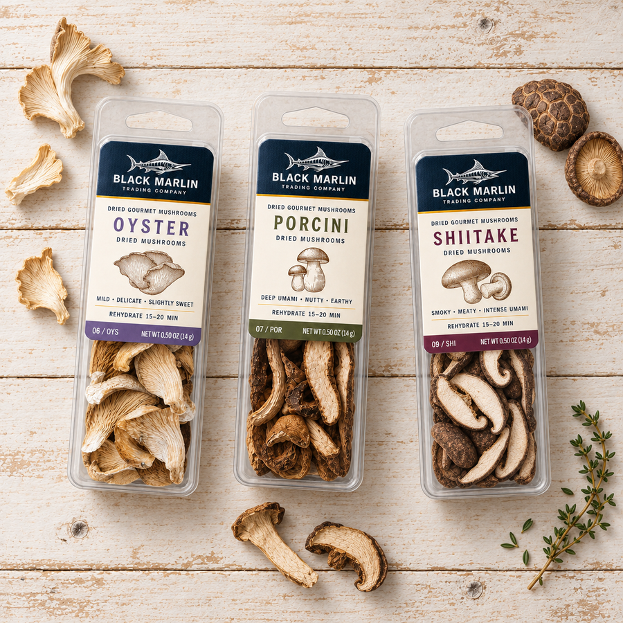 The Forager: three Forager Mushrooms clamshell packs - oyster, porcini and shiitake - on white-washed wood with dried mushroom pieces and a sprig of thyme